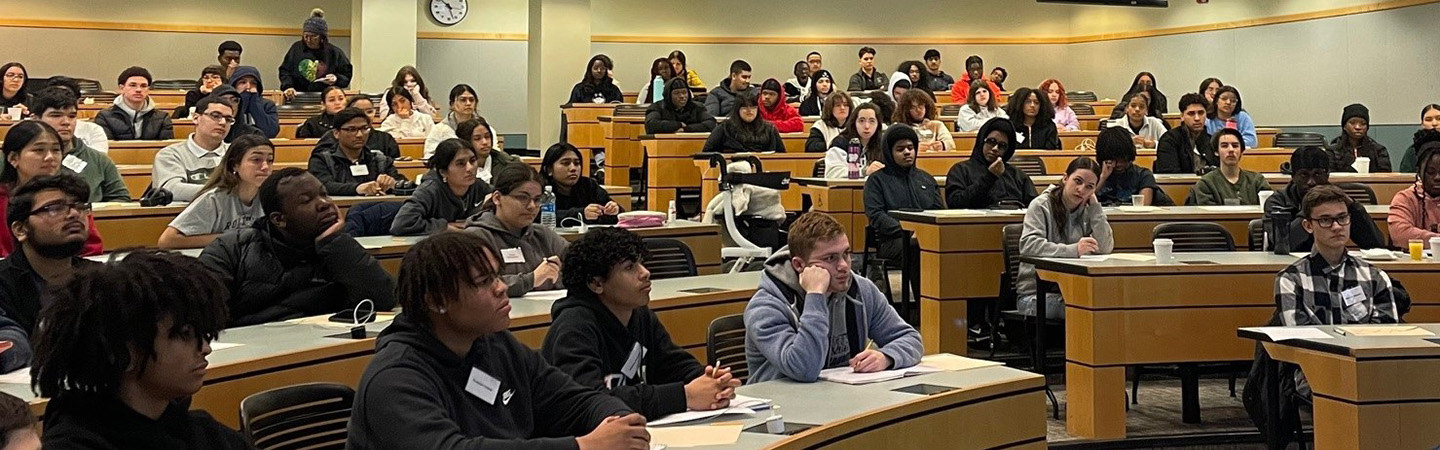 A diverse group of students seated in a UConn School of Business classroom on the Storrs campus